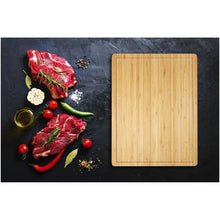 Load image into Gallery viewer, Fet bamboo steak cutting board — lifestyle